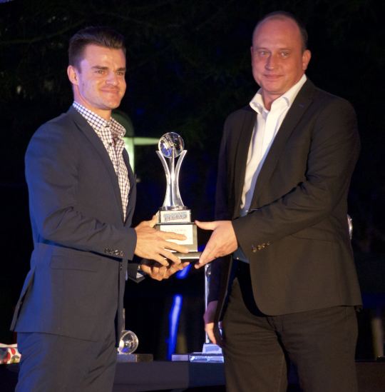Pierre Bruwer, MD of Ctrack SA, presents the Players’ Player Trophy to Titans’ opening batsman Heino Kuhn during the recent The Unlimited Titans Awards evening