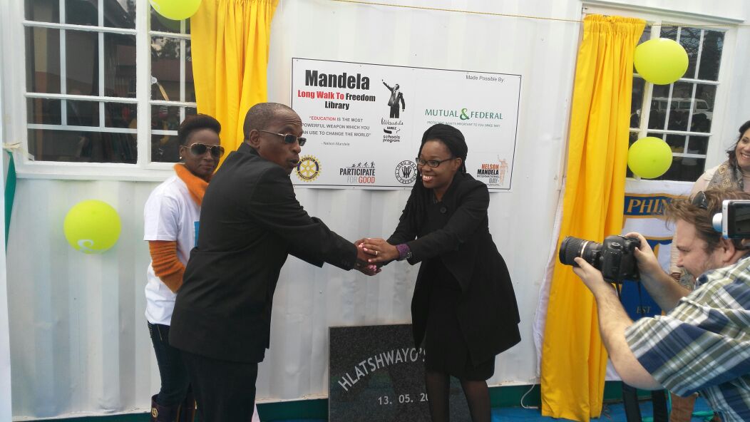 Busisiwe Sithole Mutual & Federal Head of Responsible Business handing over the library to the Principal Mr Hlatshwayo